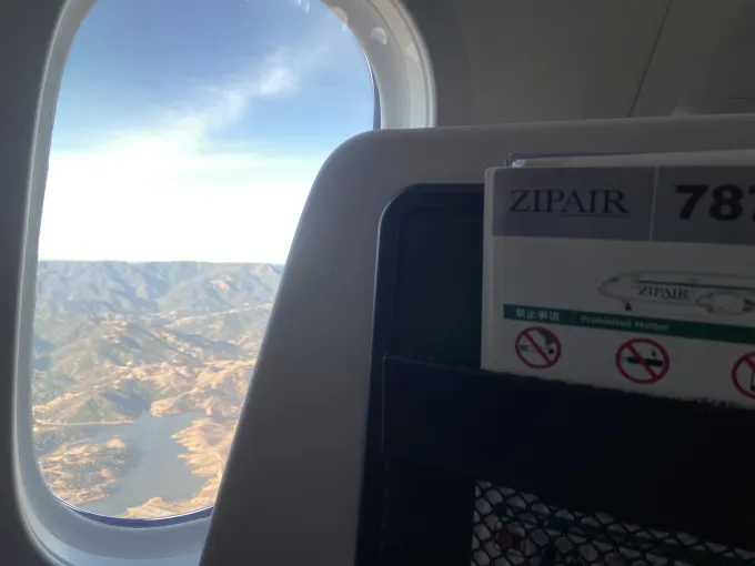 A view of flying over the mountains, from an airplane window